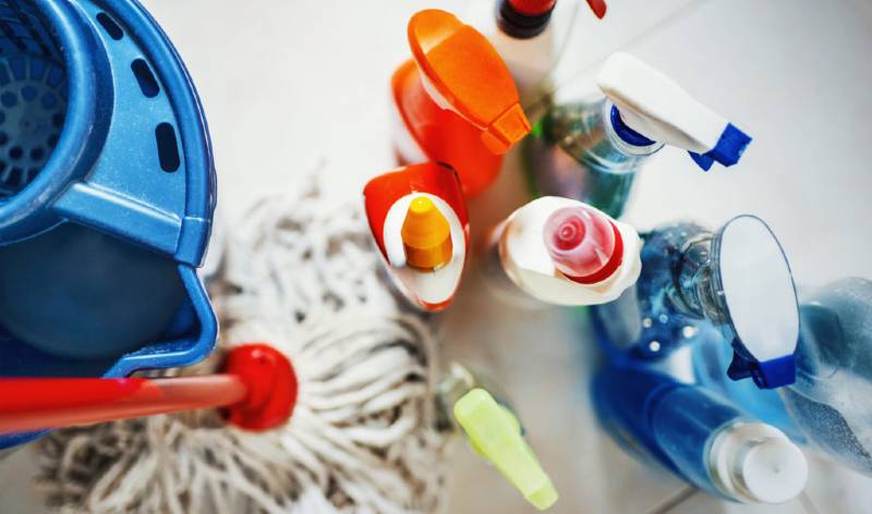 different tools, supplies, blue basket and scrubber on the floor