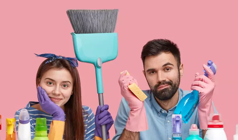 young couple with some cleaning supplies ready to clean