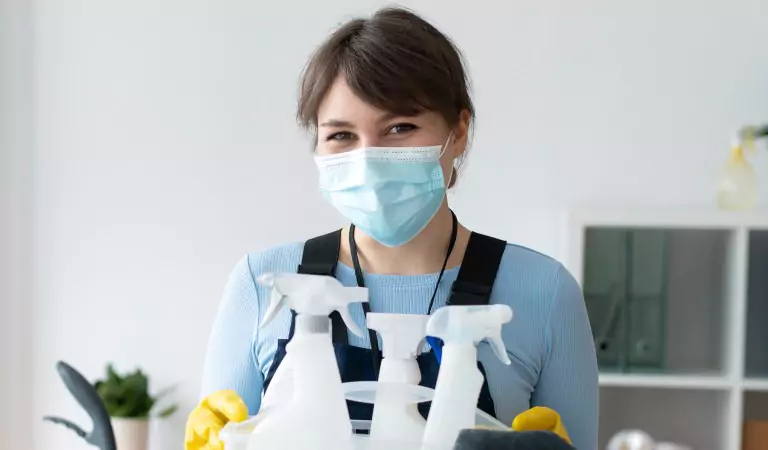 woman wearing a mask ready to clean her house