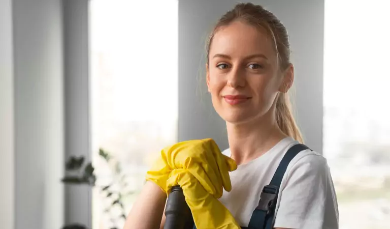 woman wearing yellow gloves looking ready to clean