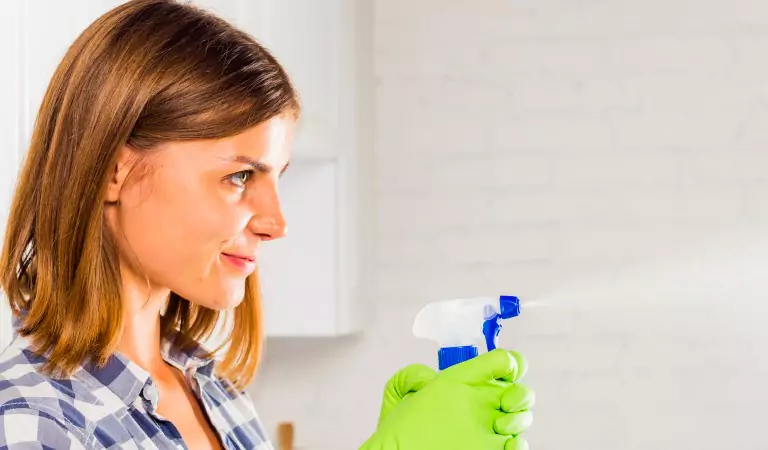 woman with a cleaning spray ready to clean