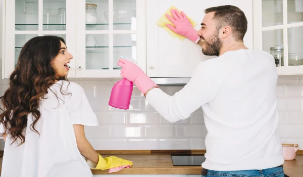 Couple cleaning kitchen together