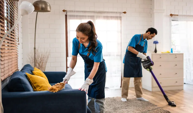 Young man and woman cleaning service worker work in living room