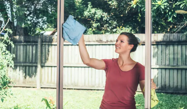 Woman standing and cleaning