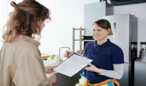 Housewife concluding a deal with cleaning service worker