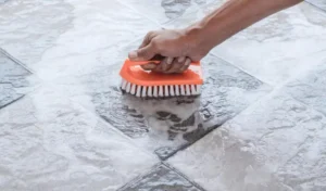 Mens hands are used to convert polishing cleaning on the tile floor