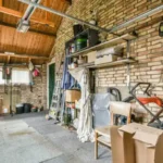 A room with brick walls and a garage with boxes