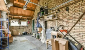 A room with brick walls and a garage with boxes
