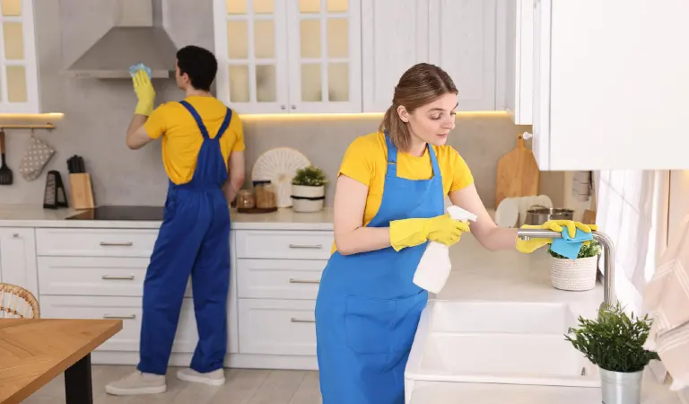 Professional janitors working in kitchen cleaning service